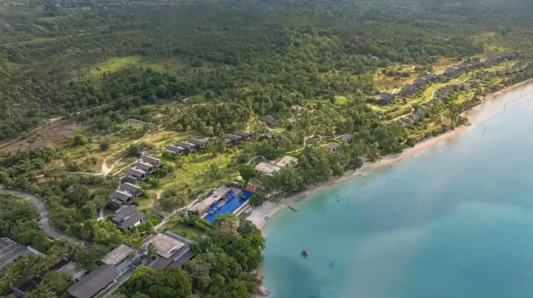 an aerial view of a beach with houses and the water at The Residence Bintan in Kawal