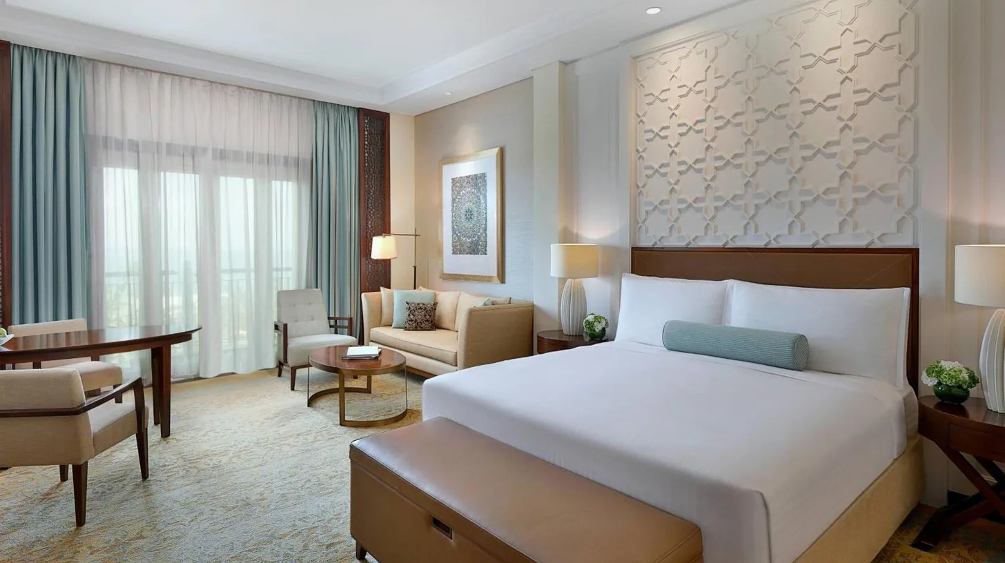 a hotel room with a bed and a couch at The Ritz-Carlton