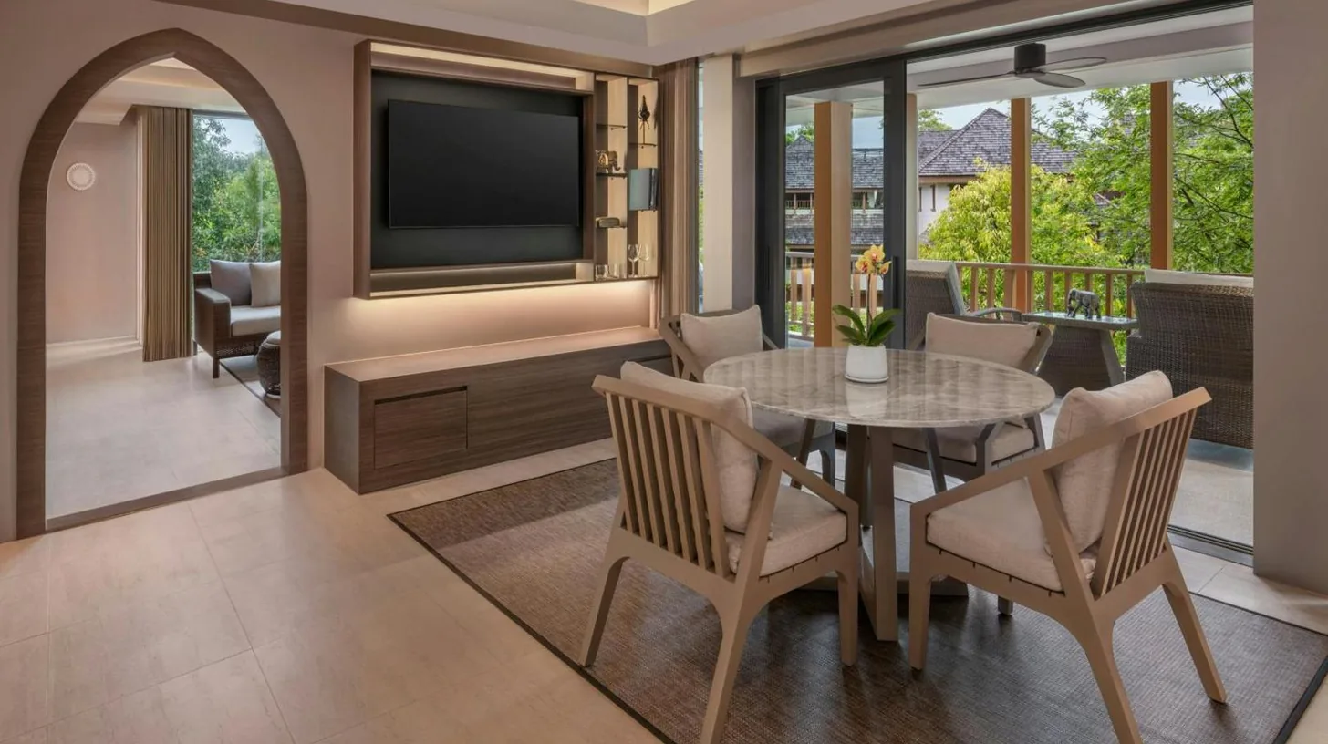 a balcony with two chairs and a table and a television at The Ritz-Carlton