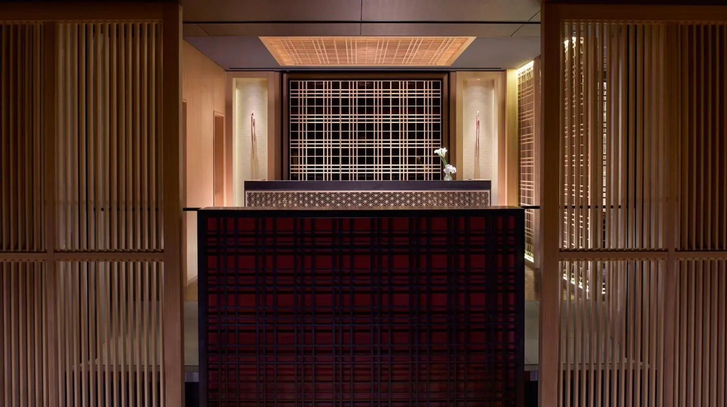a room with a wall of wooden doors and a building at The Ritz-Carlton Kyoto in Kyoto