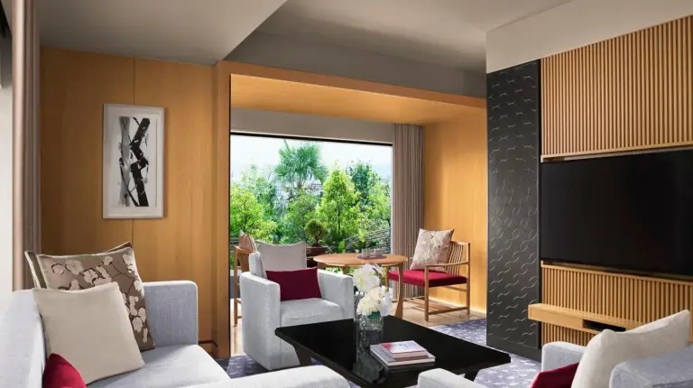 a living room with a couch and a tv at The Ritz-Carlton Kyoto in Kyoto