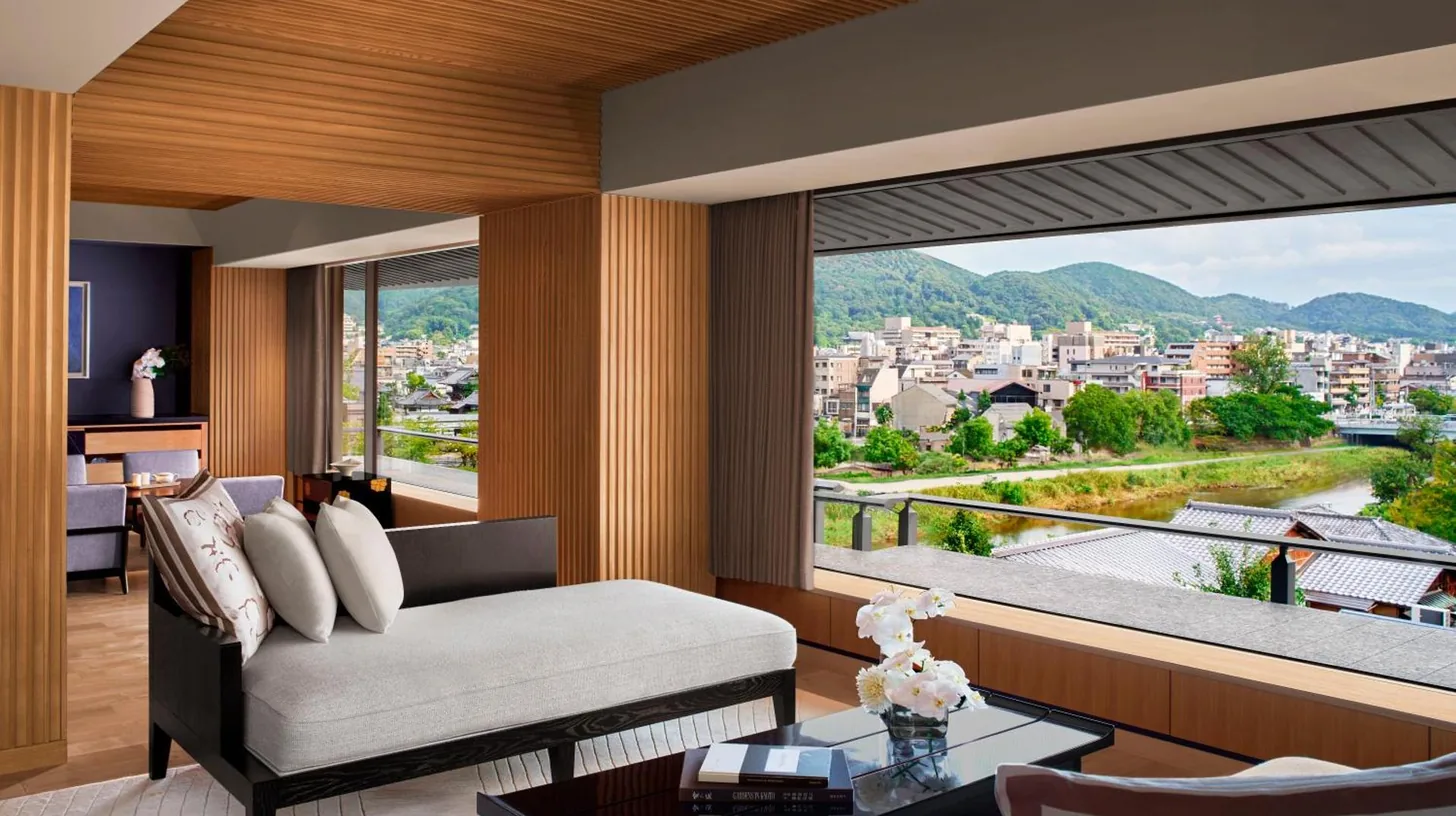 a living room with a couch and a large window at The Ritz-Carlton Kyoto in Kyoto