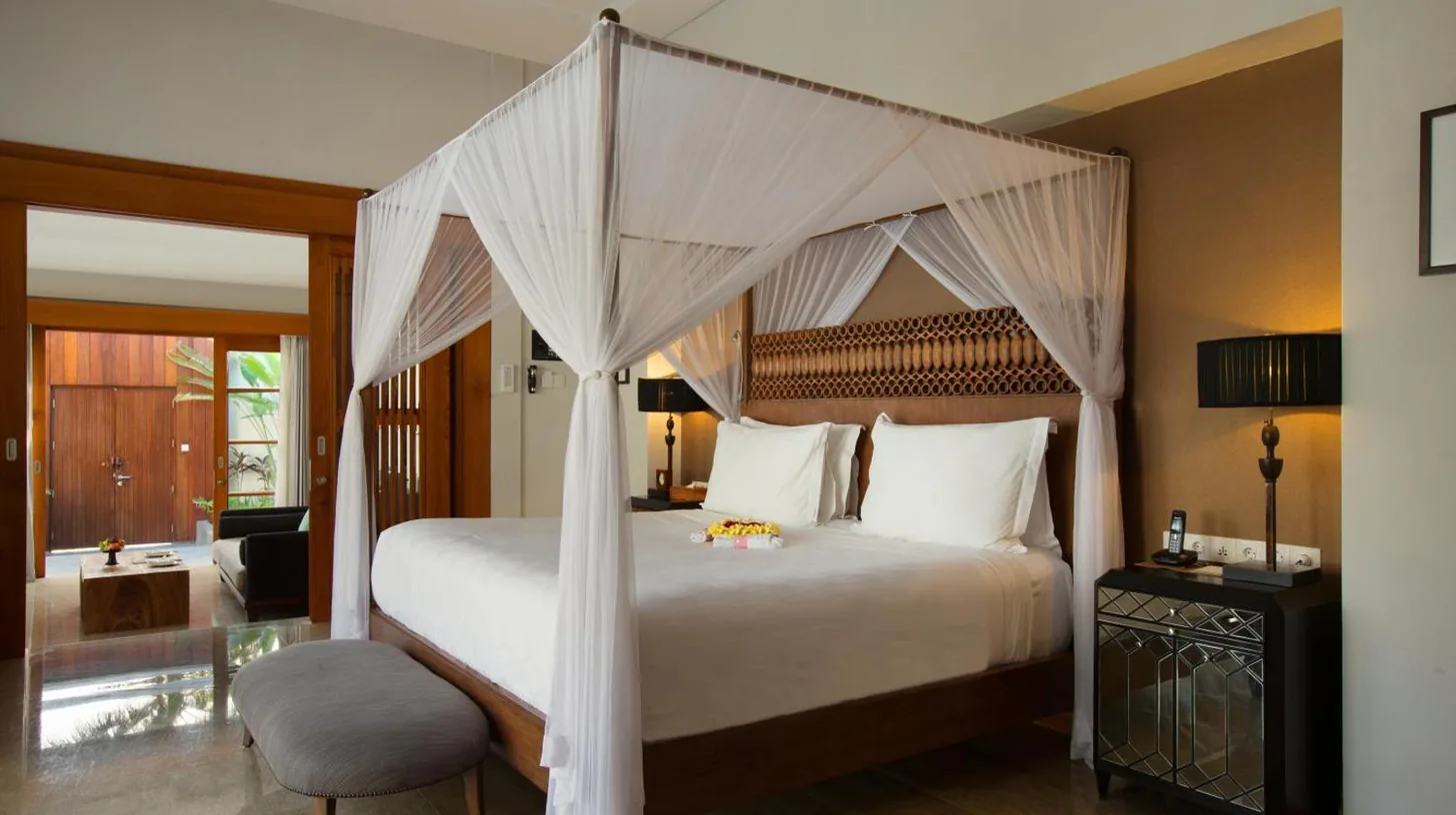 a bedroom with a white bed with a canopy at The Samaya Seminyak Bali in Seminyak