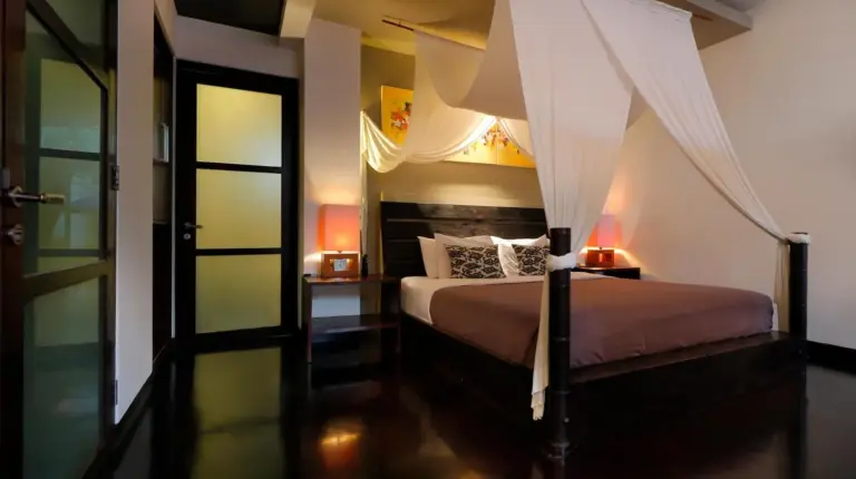 a bedroom with a bed with a canopy at The Seiryu Boutique Bali Villas in Seminyak