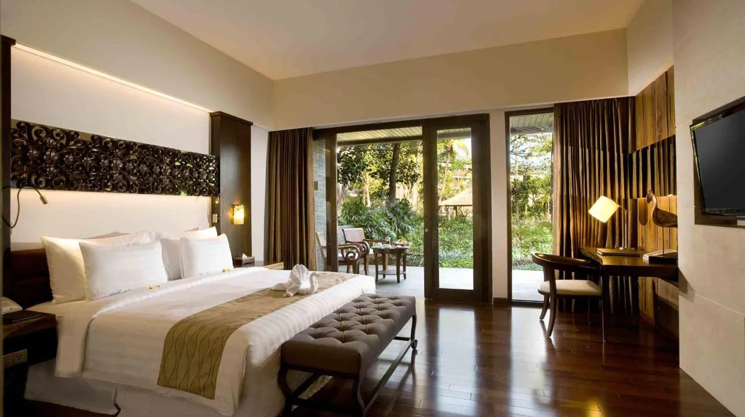 a large bedroom with a large bed and a television at The Seminyak Beach Resort & Spa in Seminyak