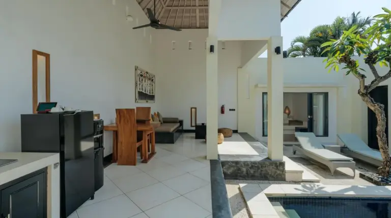 a kitchen and living room of a house with a pool at The Seminyak Suites Private Villas in Seminyak