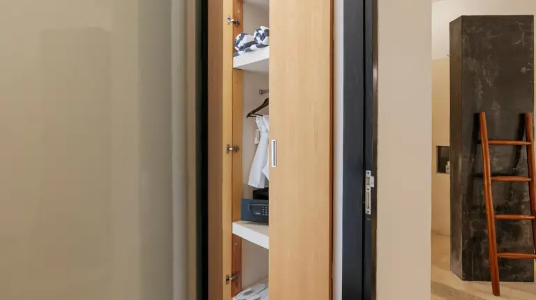 a closet with wooden shelves and a door at The Seminyak Suites Private Villas in Seminyak