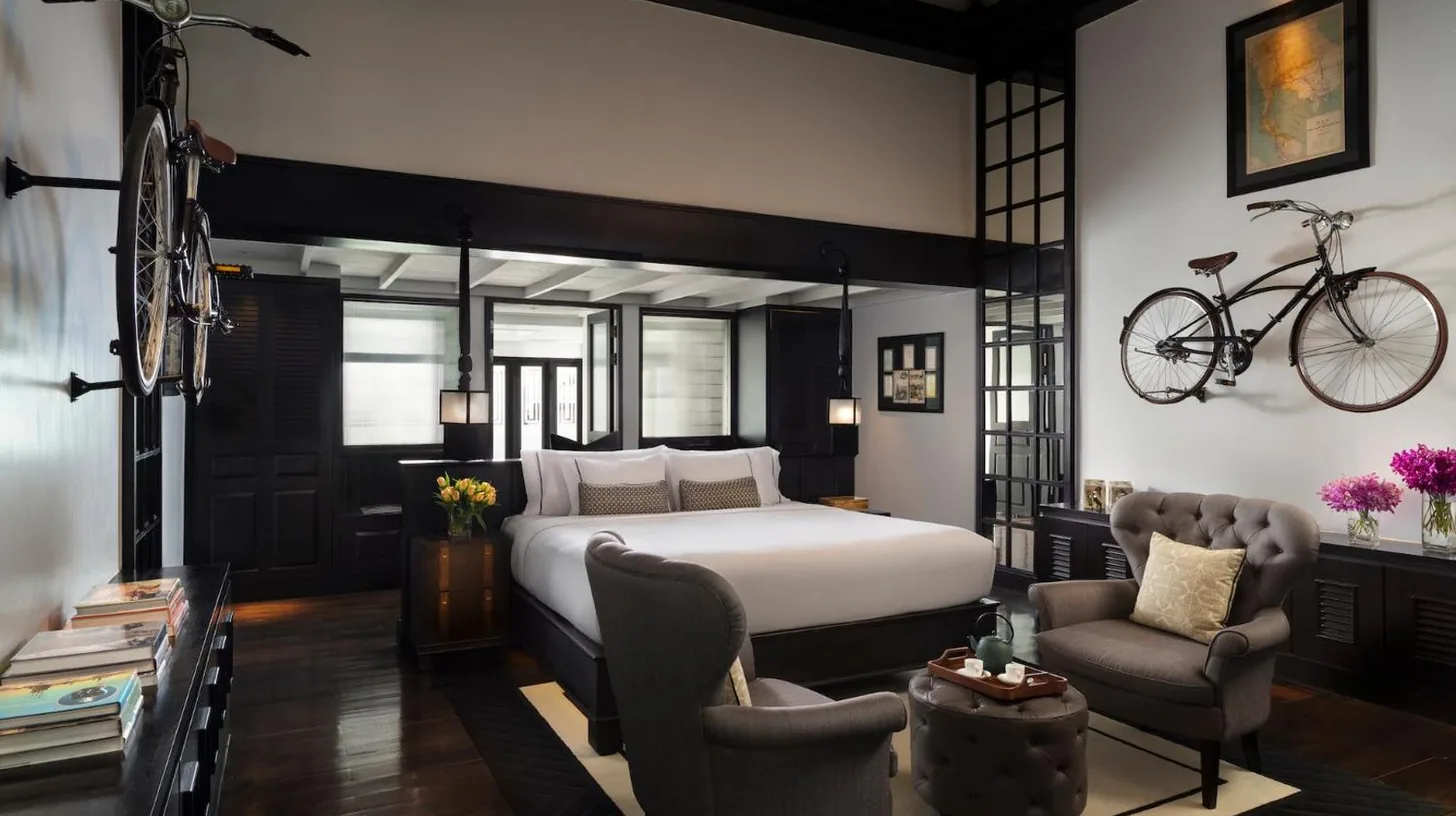 a bedroom with a bed and a bicycle on the wall at The Siam in Bangkok