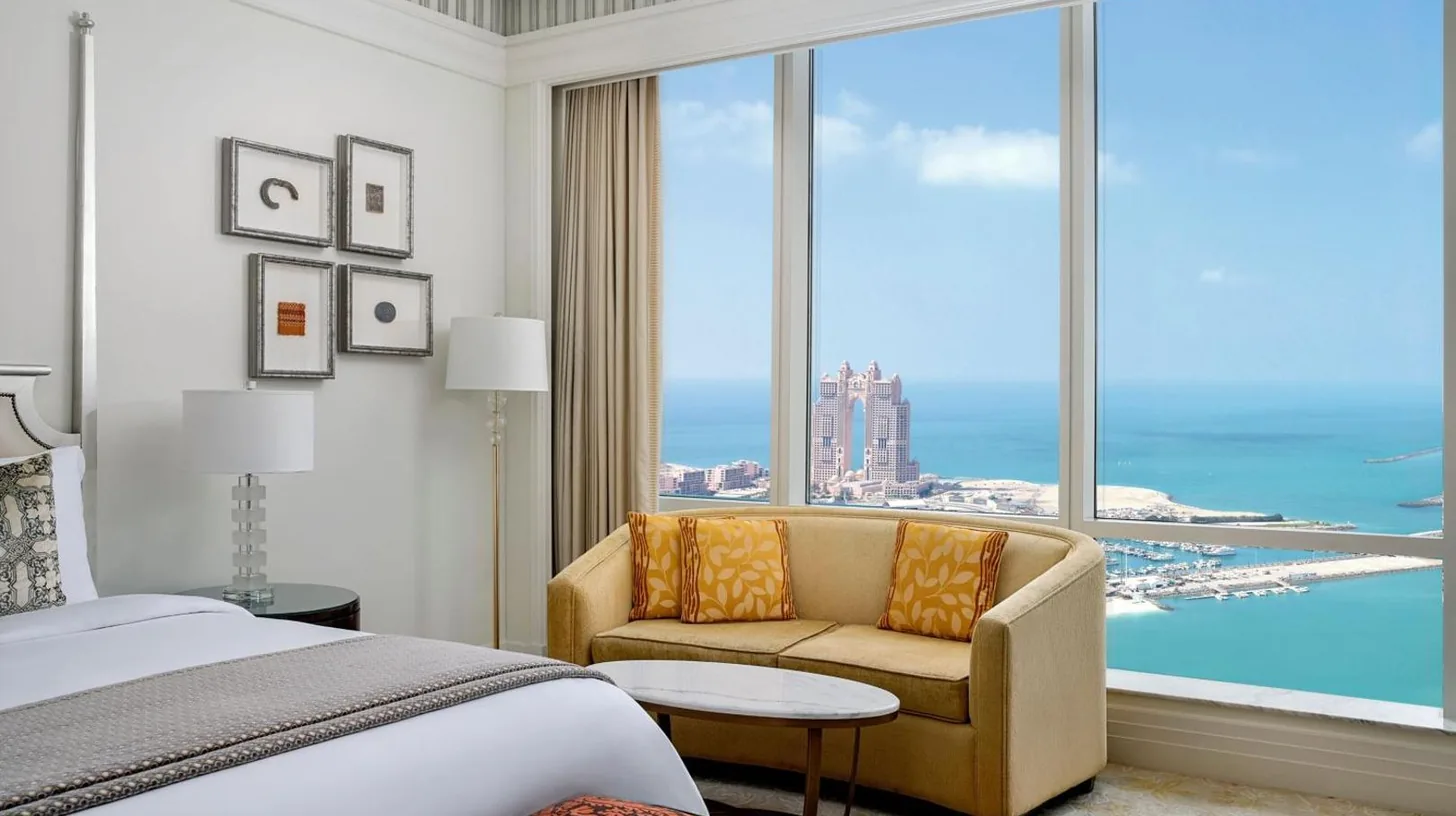 a hotel room with two beds and a desk at The St. Regis Abu Dhabi in Abu Dhabi