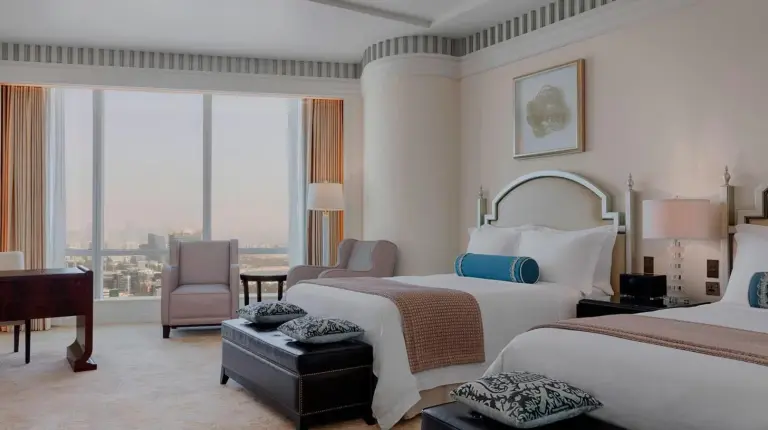 a bedroom with a large bed with a large window at The St. Regis Abu Dhabi in Abu Dhabi