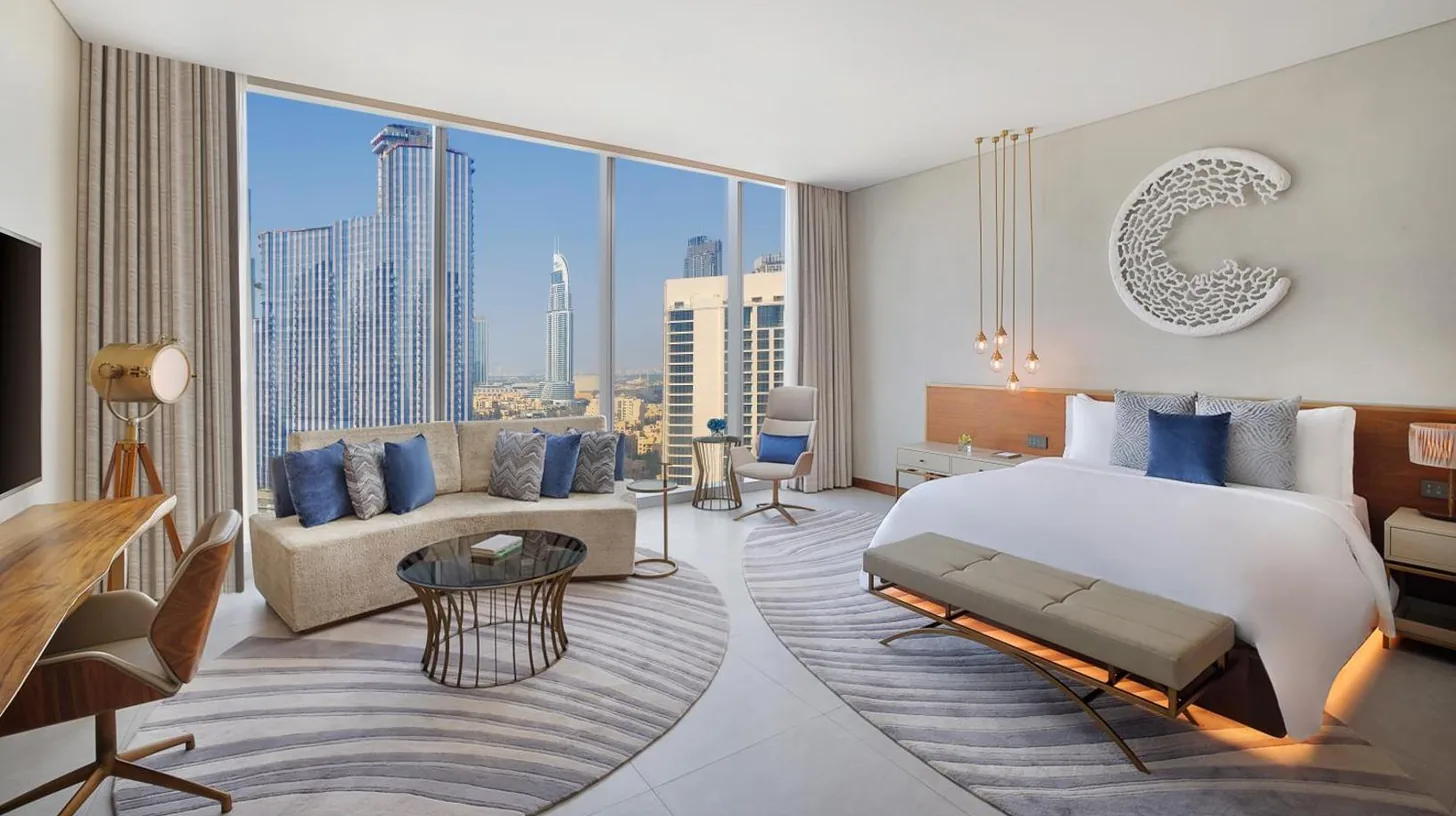 a bedroom with a king sized bed and a couch at The St. Regis Downtown Dubai in Dubai