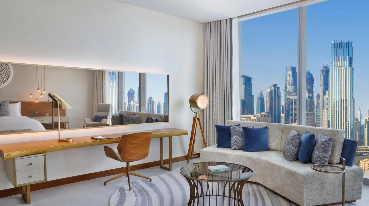 a hotel room with a desk and a bed at The St. Regis Downtown Dubai in Dubai