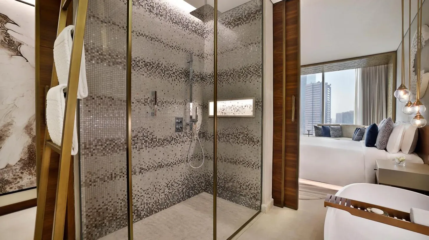 a bathroom with a shower with a toilet and a sink at The St. Regis Downtown Dubai in Dubai