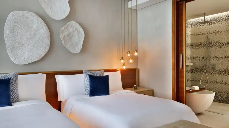 a bedroom with two beds and a window at The St. Regis Downtown Dubai in Dubai