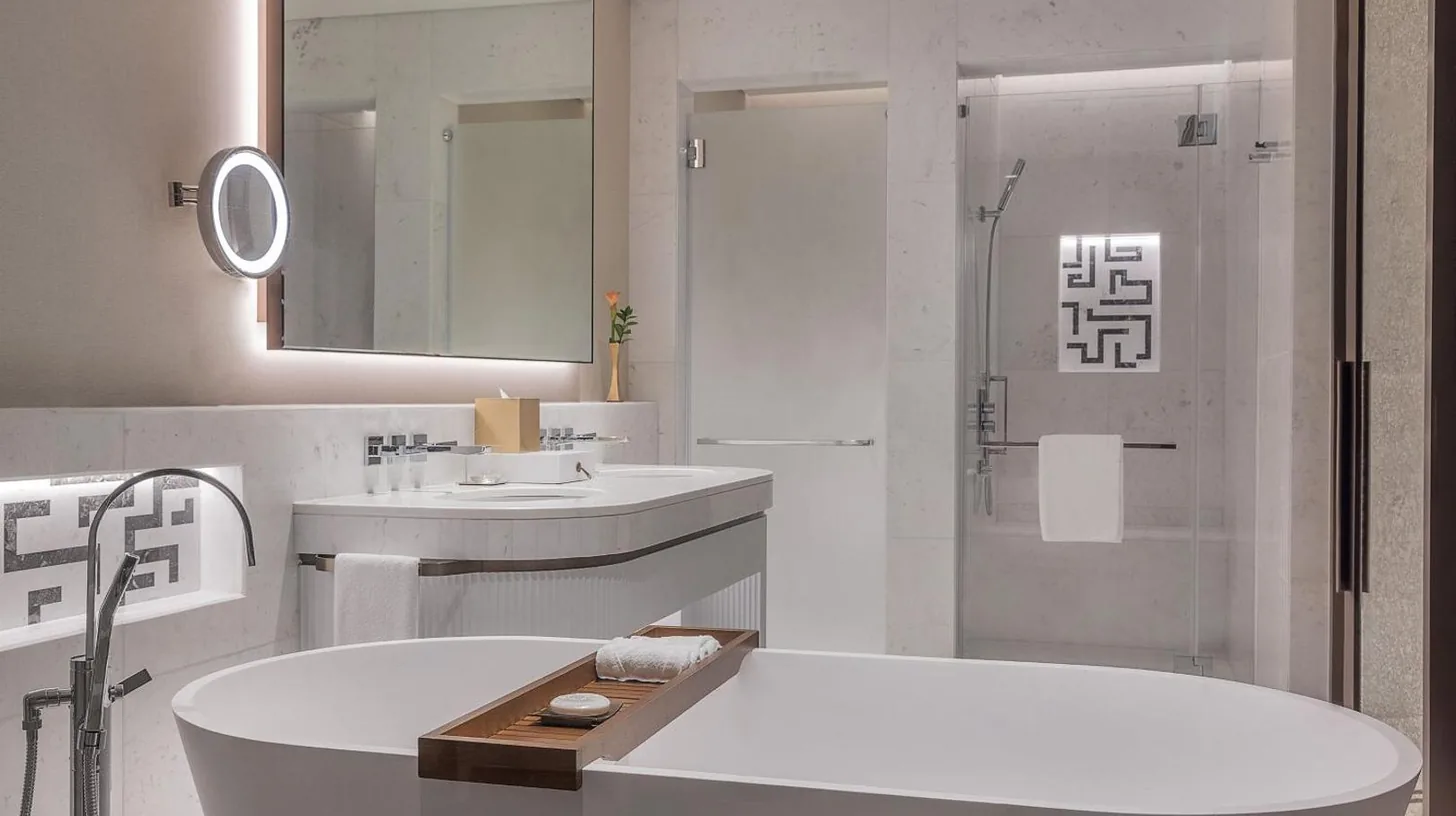 a bathroom with two sinks and a large mirror at The St. Regis Dubai