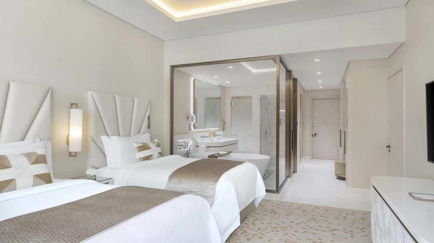 a white bathroom with a sink and a mirror at The St. Regis Dubai