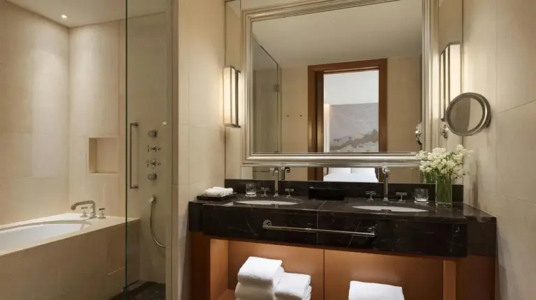 a bathroom with a sink and a tub and a mirror at The St. Regis Osaka in Osaka