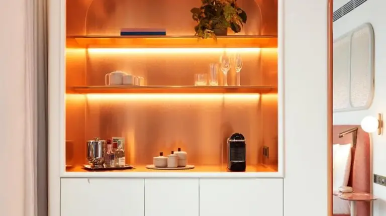 a room with a white cabinet with a tv at The Standard