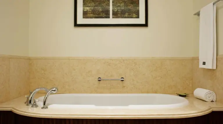 a bath tub in a bathroom with a picture on the wall at The Westin Dubai Mina Seyahi Beach Resort and Waterpark in Dubai