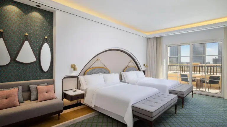 a bedroom with a large white bed and a balcony at The Westin Dubai Mina Seyahi Beach Resort and Waterpark in Dubai