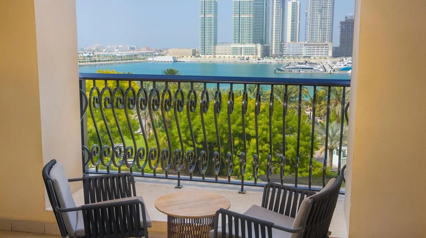 a balcony with two chairs and a table and a view at The Westin Dubai Mina Seyahi Beach Resort and Waterpark in Dubai