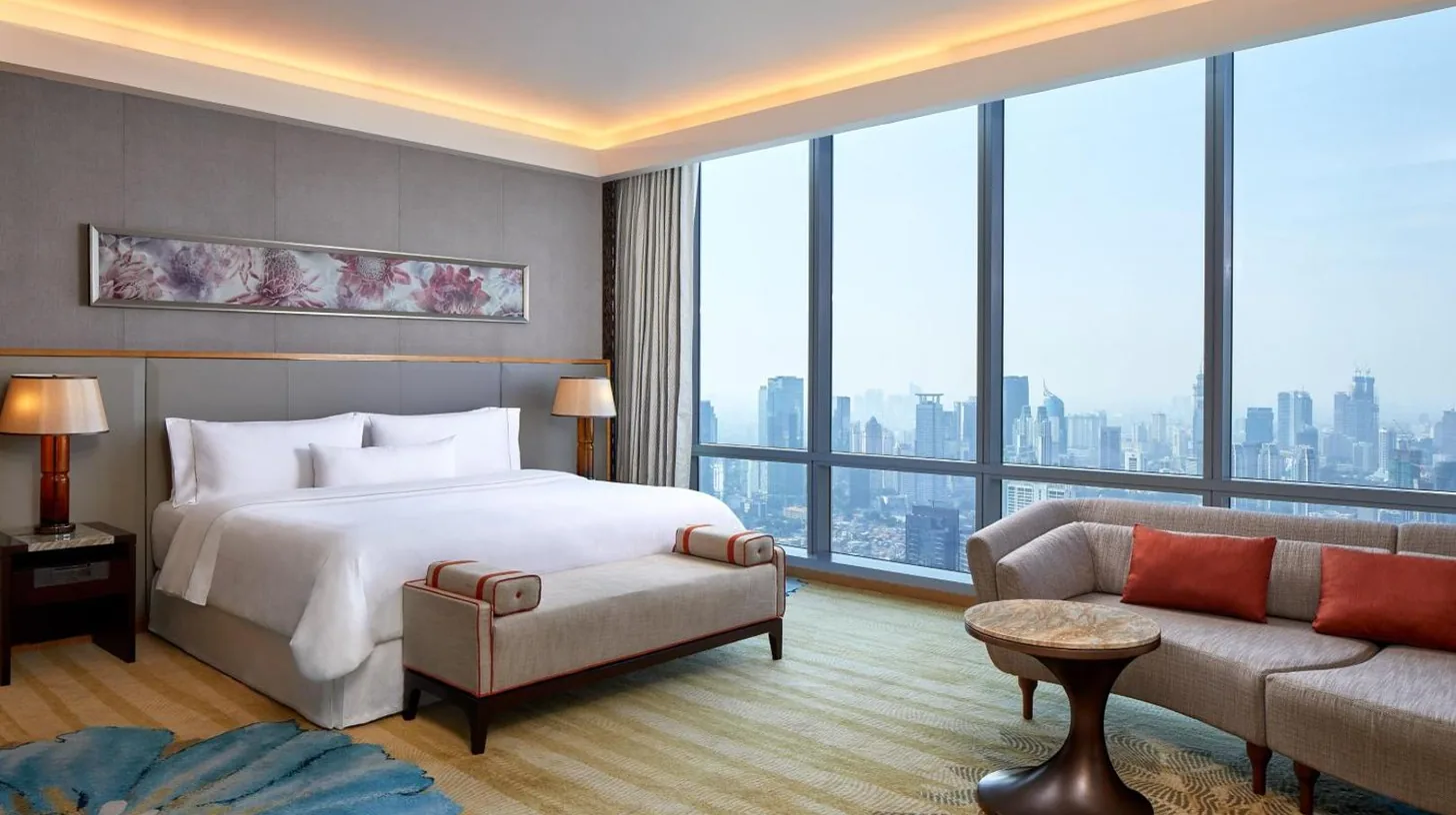a hotel room with a bed and a couch at The Westin Jakarta in Jakarta