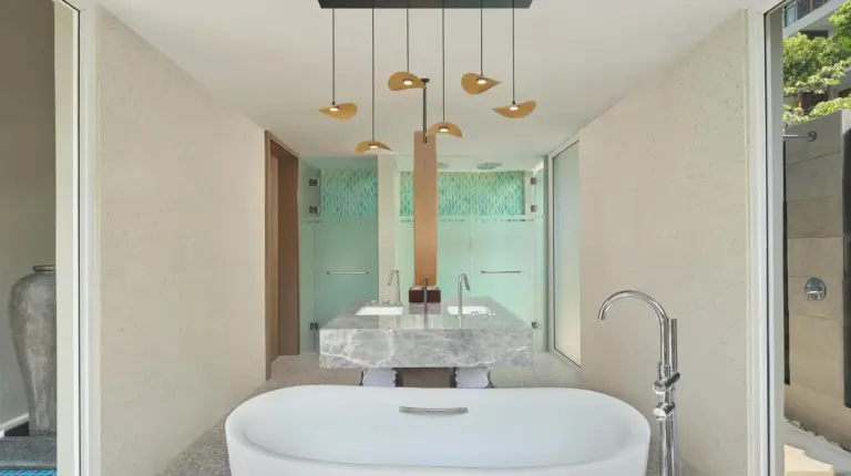 a bathroom with a large tub and a sink at The Westin Nirup Island Resort & Spa in Belakangpandang