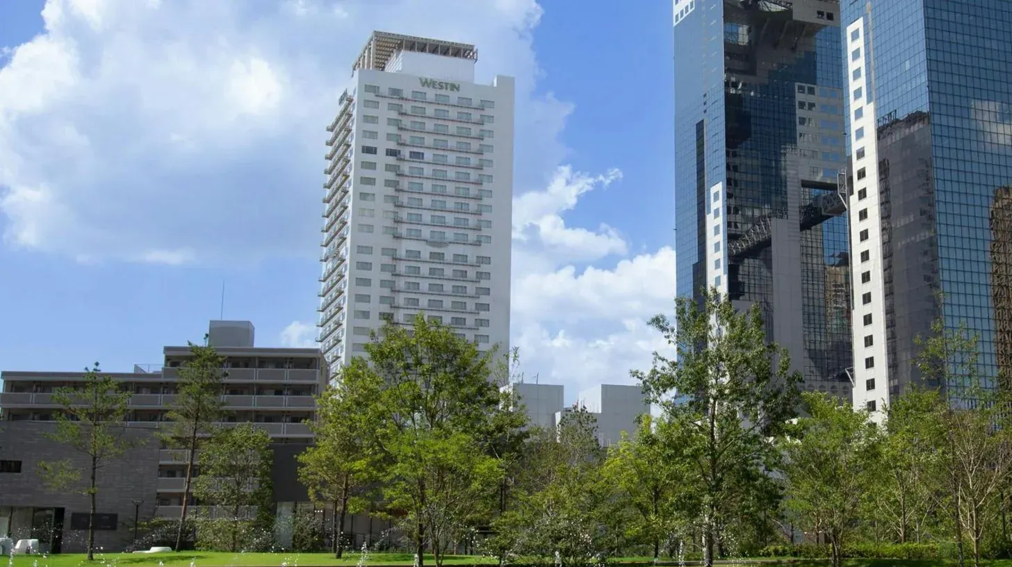 a city skyline with tall buildings and a park at The Westin Osaka in Osaka