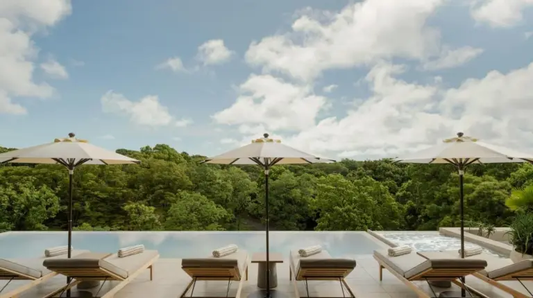 a patio with chairs and umbrellas and a pool at TRUNK(HOTEL) YOYOGI PARK in Tokyo