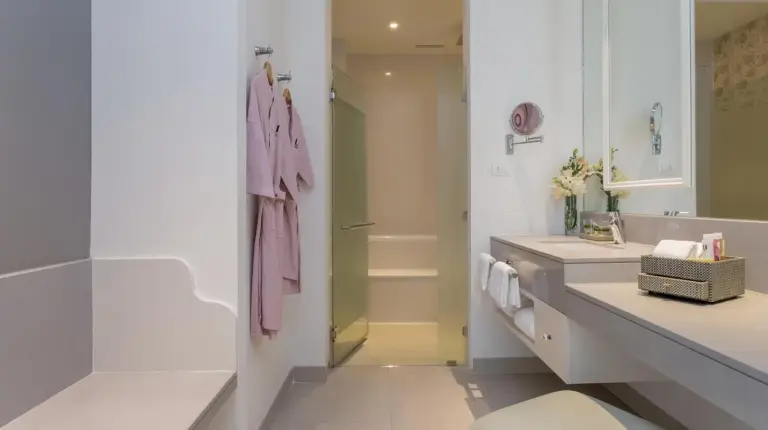 a bathroom with a sink and a toilet and a mirror at U Sathorn Bangkok in Bangkok