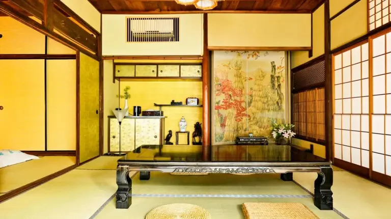 a room with a table in the middle of a room at Udatsuya in Osaka