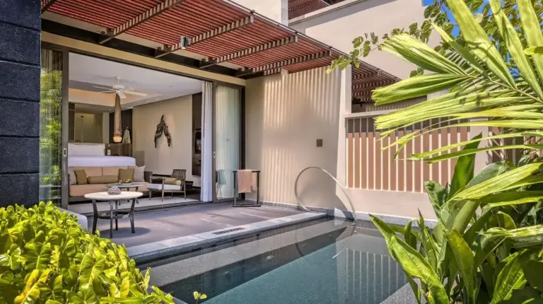 a bedroom with a bed and a swimming pool at Vana Belle