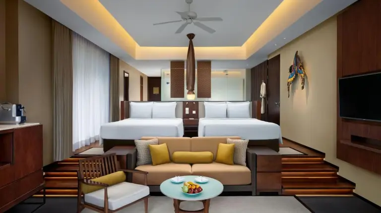 a bedroom with a bed and a couch and a table at Vana Belle