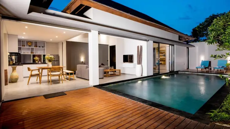 a villa with a swimming pool and a dining area at Villa DeDayuh Seminyak in Seminyak