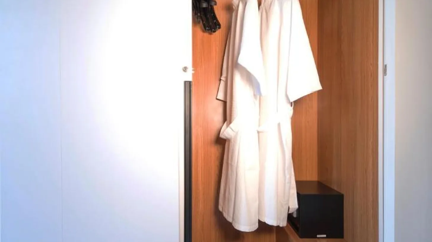 a closet with white clothes and a box at Villa DeDayuh Seminyak in Seminyak