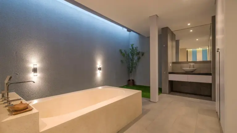 a bedroom with a bed and a flat screen tv at Villa DeDayuh Seminyak in Seminyak