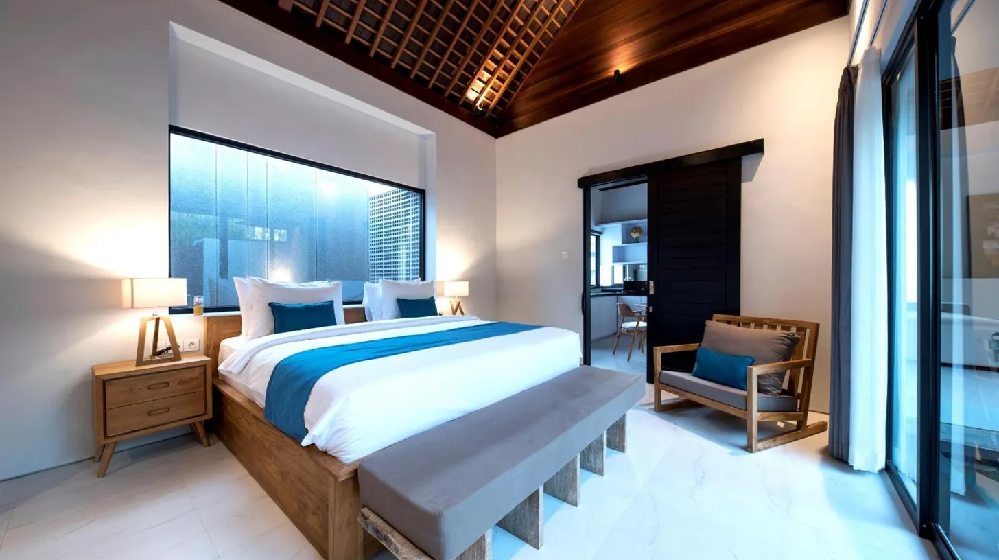 a kitchen and living room with a table and a couch at Villa DeDayuh Seminyak in Seminyak