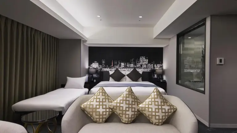 ein Hotelzimmer mit Bett und Sofa im Villa Fontaine Premier Haneda Airport – Direkt mit Terminal 3 des Haneda Airport verbunden in Tokio