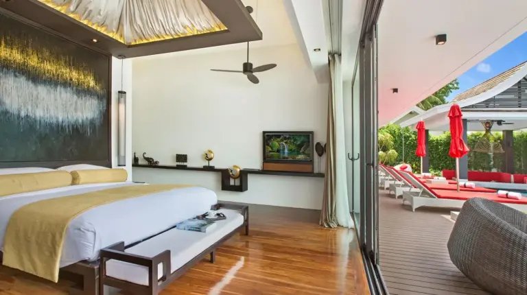 a bedroom with a bed and a living room at Villa Julia koh Samui beach with Cook and Majordome in Lamai