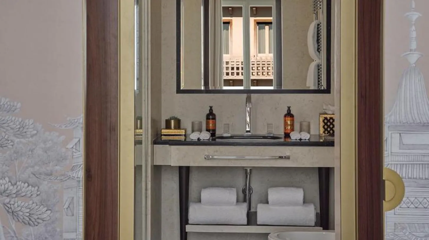 a bathroom with a sink and a toilet and a mirror at Violino d'Oro Venezia in Venice