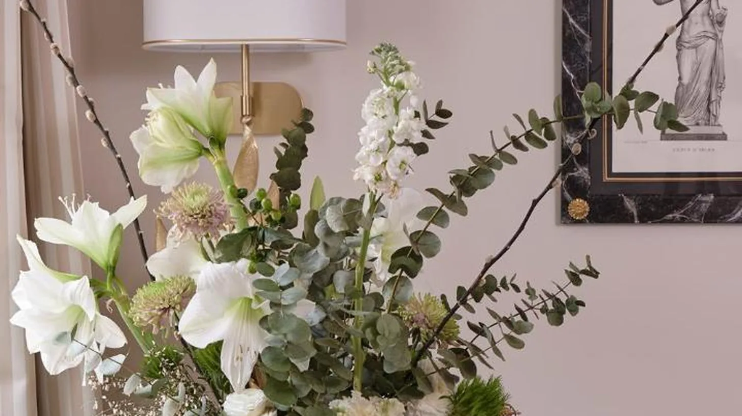 a vase filled with white flowers on a table at Violino d'Oro Venezia in Venice