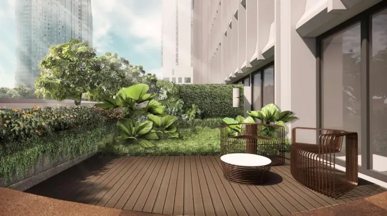 a lobby with a yellow couch and tables and chairs at voco Bangkok Surawong by IHG in Bangkok
