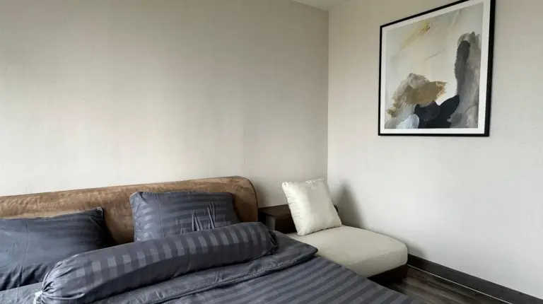 a large bed in a room with a large window at W8 CONDO