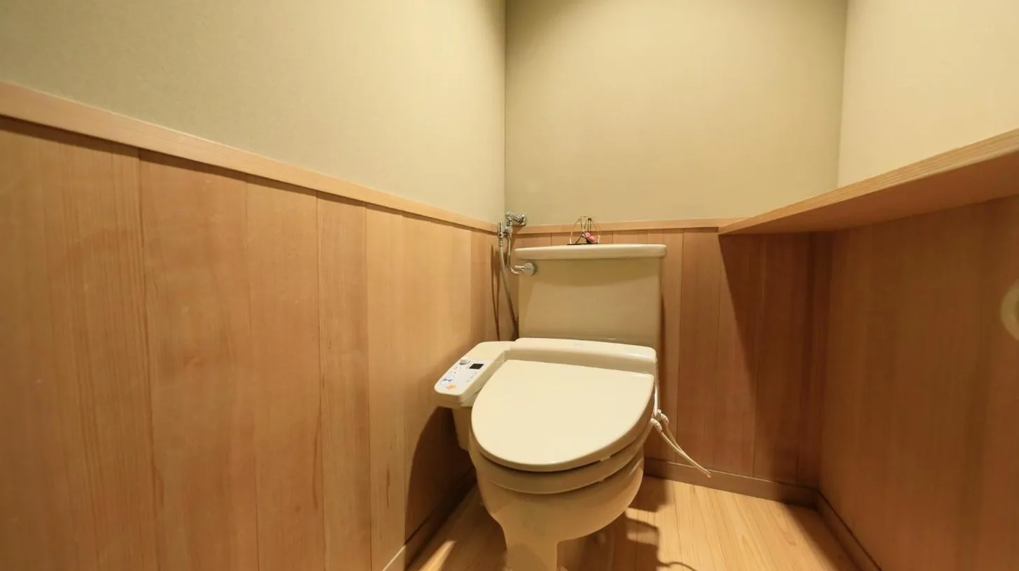 une salle de bain avec des toilettes blanches dans une chambre au Wakamatsu Hot Spring Resort à Hakodate