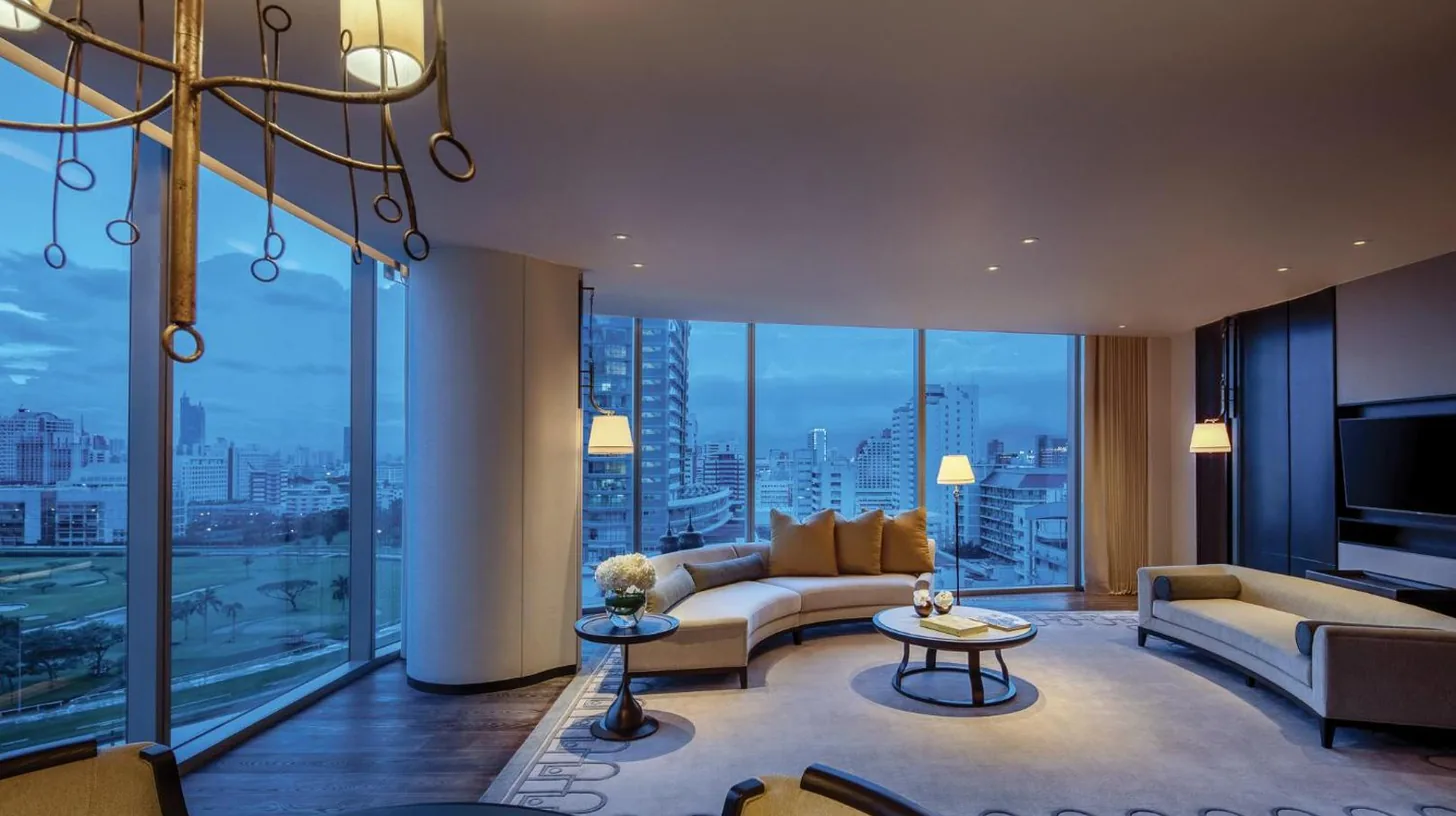 a bathroom with a tub and a large mirror at Waldorf Astoria Bangkok in Bangkok