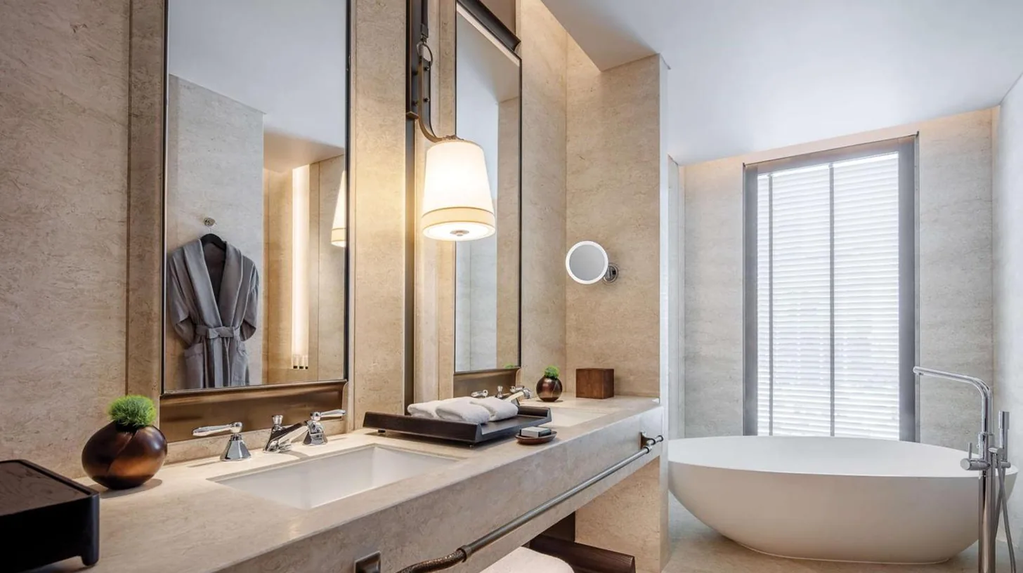 a kitchen with wooden cabinets with a desk in it at Waldorf Astoria Bangkok in Bangkok
