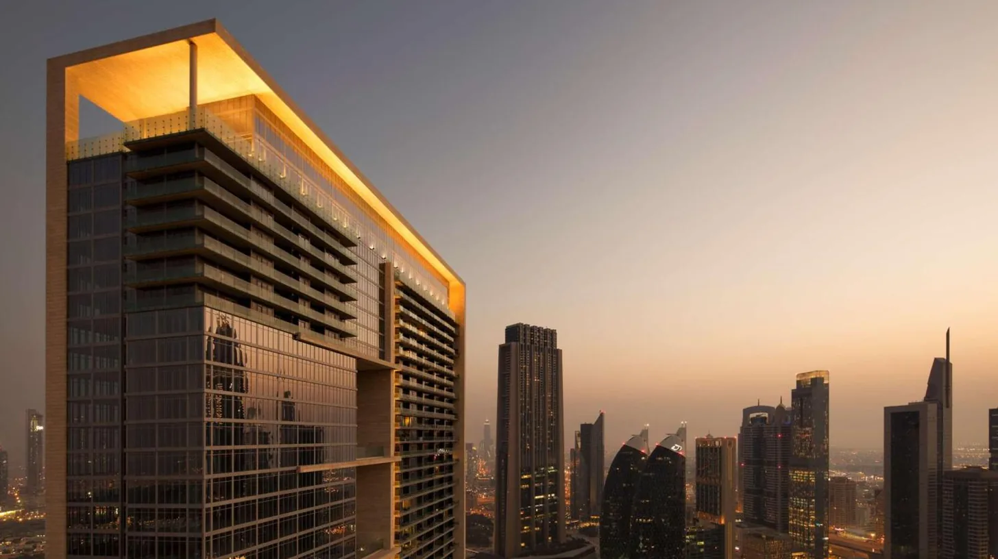 a tall building in the middle of a city at Waldorf Astoria Dubai International Financial Centre in Dubai
