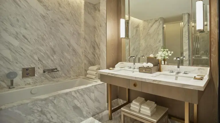 a bathroom with a tub and a sink and a bath tub at Waldorf Astoria Dubai International Financial Centre in Dubai