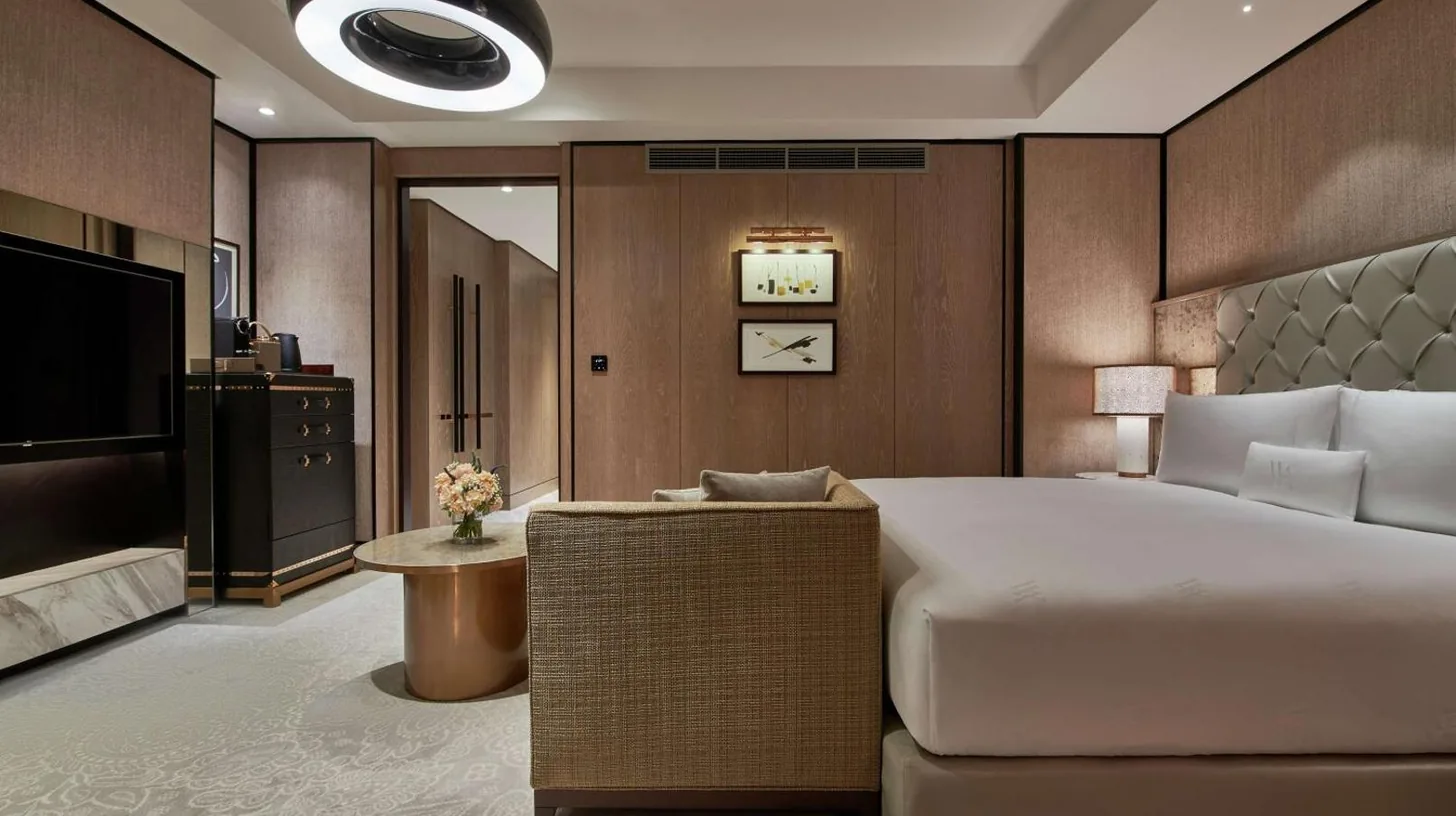 a bedroom with a large bed and a television at Waldorf Astoria Dubai International Financial Centre in Dubai