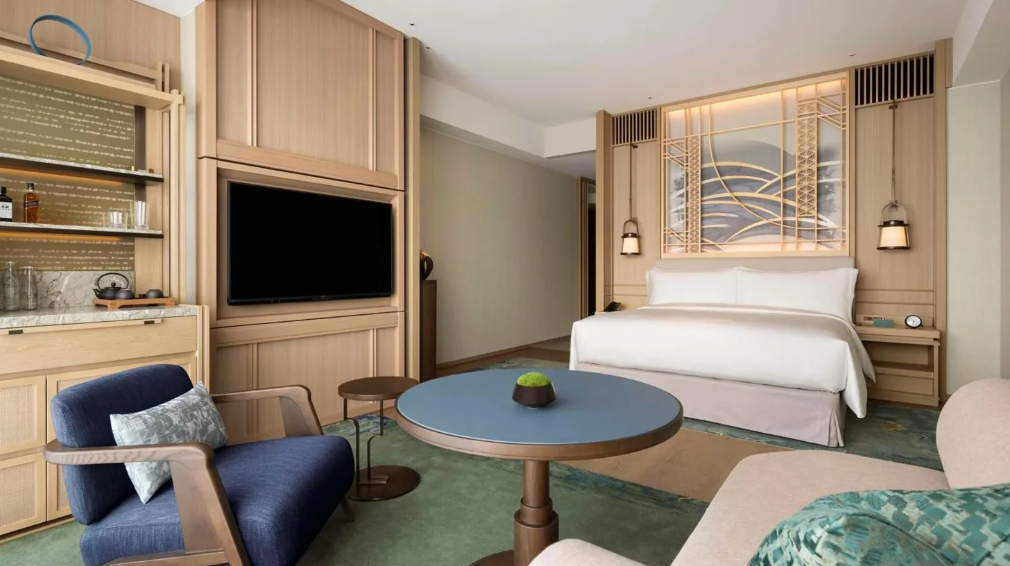 a hotel room with a bed and a table at Waldorf Astoria Osaka in Osaka